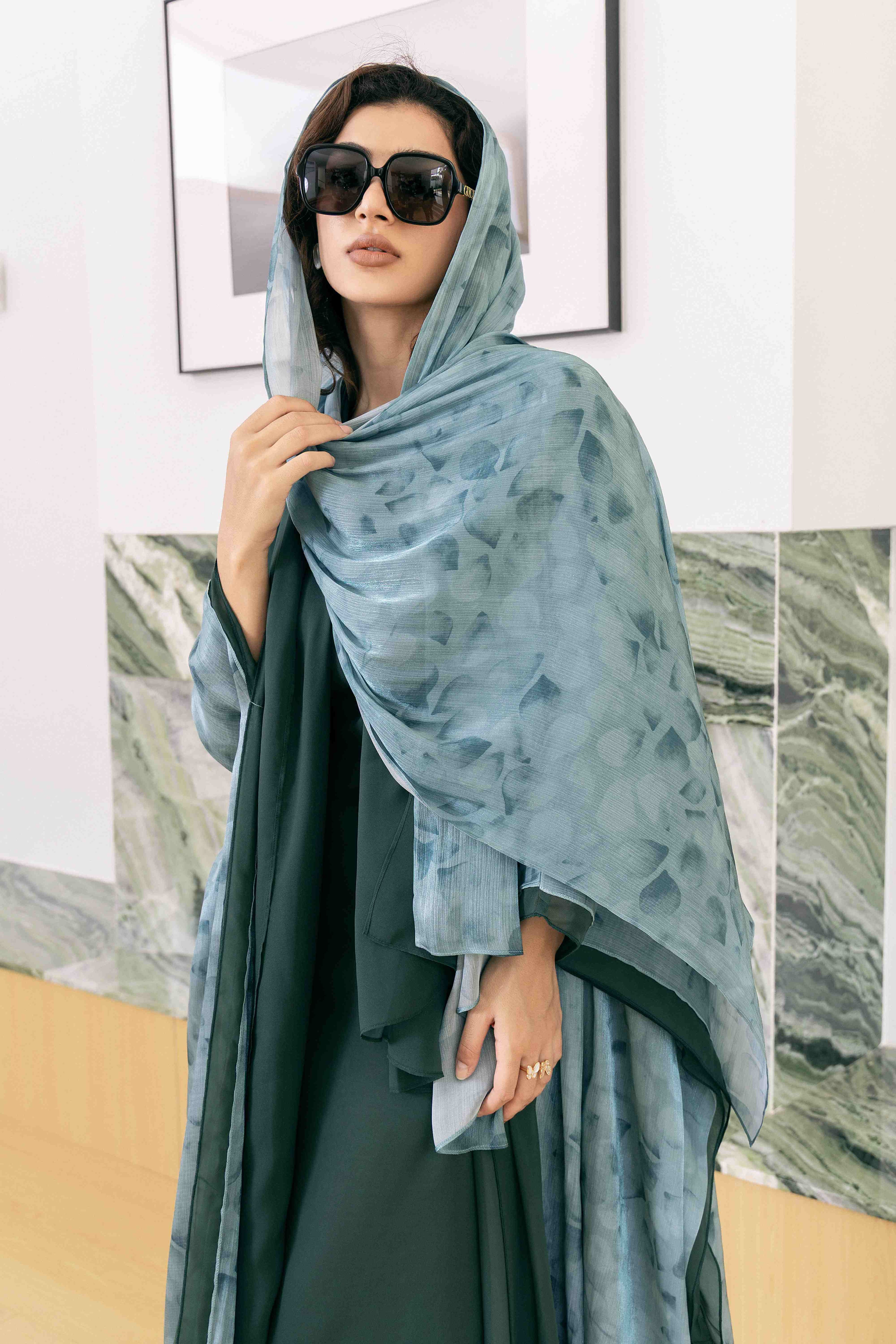 Angled silhouette of the Garden Green Abaya set against a soft background