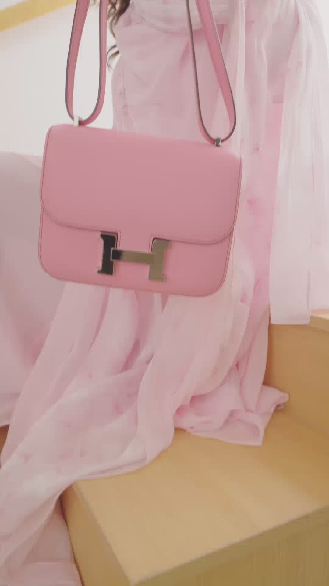Artistic shot of Light Pink Floral Abaya styled with a matching pink handbag